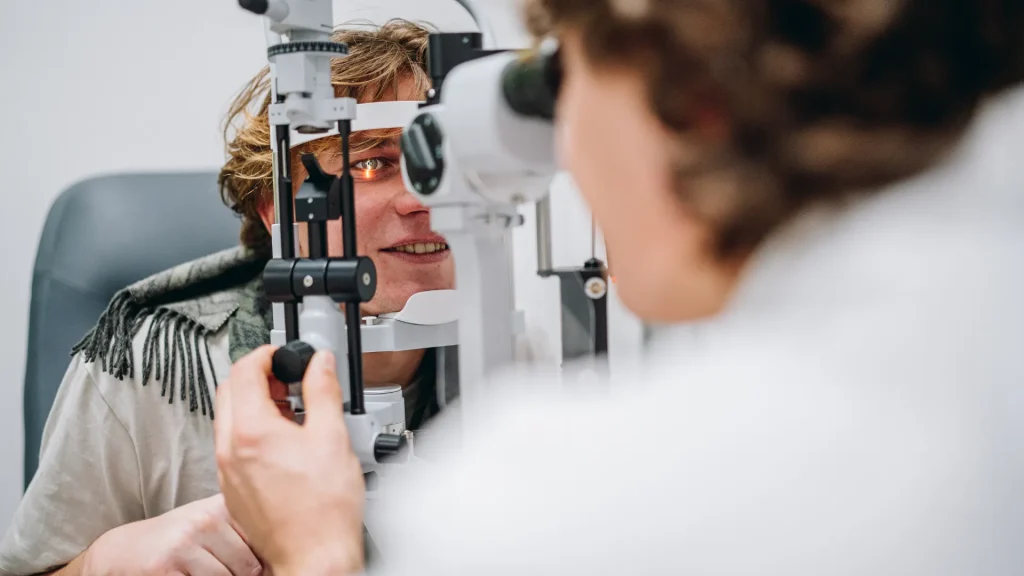 Patient undergoing an eye exam with a slit lamp to check for digital eye strain and other vision issues.