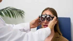 opthalmologist performing a vision test using a phoropter during an eye exam