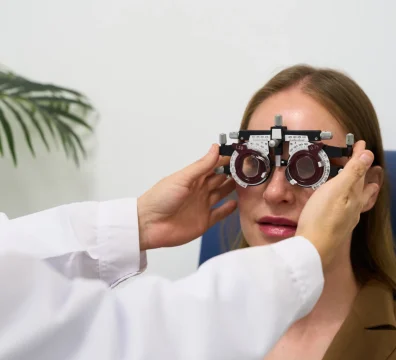 opthalmologist performing a vision test using a phoropter during an eye exam