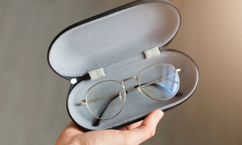 Eyeglasses in protective case recommended by eye doctors for clear vision.